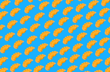 Raw pasta diagonally arranged on a blue background
