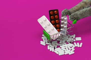 Cure for diseases in a grocery cart on a lilac background, cat legs pushing a basket of pills