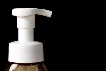 Fototapeta na wymiar Close-up Hand wash foam bottle for protection Coronavirus disease 2019 (COVID-19), Sanitizer pump bottle,black background