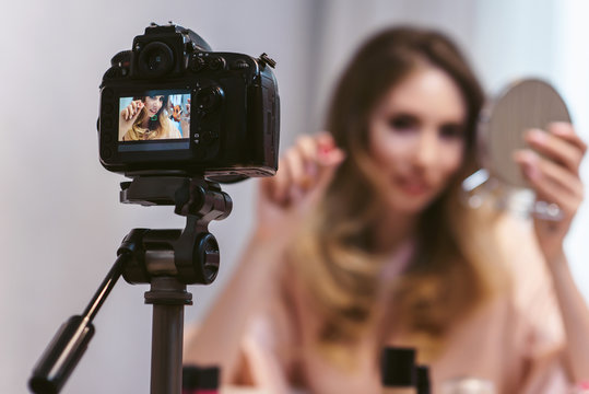 Close up famous blogger. Young attractive woman fashion vlogger talking to camera about cosmetics and showing make up techniques while recording a beauty vlog. Blogging as a lifestyle of modern women