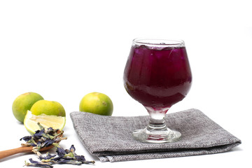 Glass of delicious roselle juice with fresh roselle on white background.