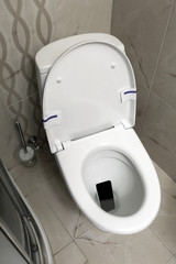 Smartphone dropped into toilet bowl indoors, above view