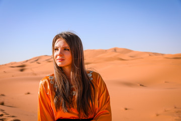 Fototapeta premium A girl in a beautiful Moroccan dress. Merzouga Morocco.