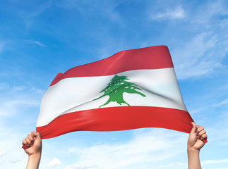 Two hands are holding a Lebanon flag - flowing through the wind. 3D Illustration.