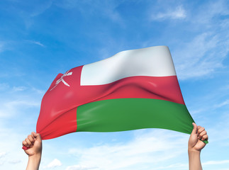 Two hands are holding an Oman flag - flowing through the wind. 3D Illustration.