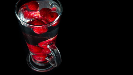 
Raspberries in a water glass. Free entry space.