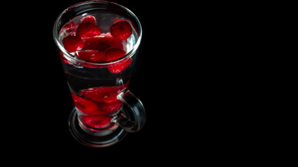 
Raspberries in a water glass. Free entry space.