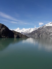 Obraz premium Alaska glacier, lake, canal, mountains and snow with a clear blue sky on a sunny spring day 2018