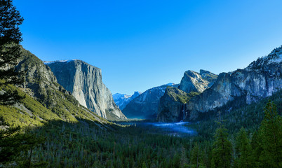 Panoramic view of the early morning sunlights and fog filling Yosemite Valley