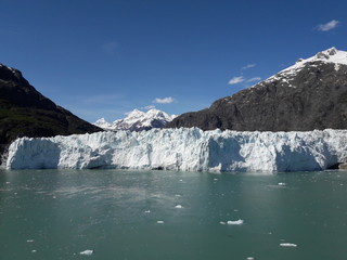Fototapeta na wymiar Alaska glacier, lake, canal, mountains and snow with a clear blue sky on a sunny spring day 2018