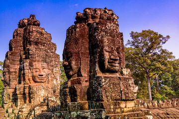 Stone Reliefs head on towers at the Bayon Temple in Angkor Thom