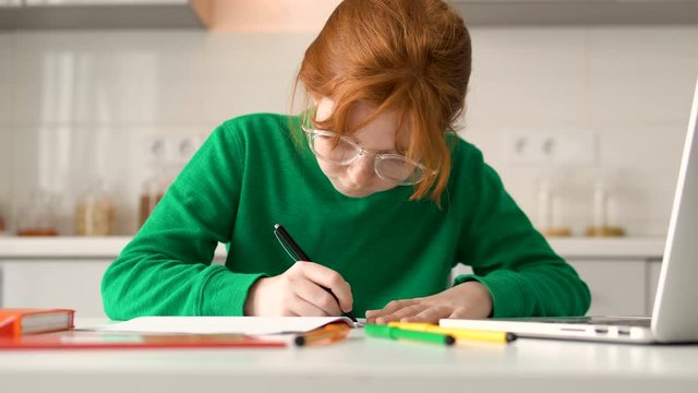 Painstaking girl drawing something in notebook, creativity and inspiration, home