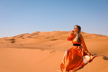 A girl in a beautiful Moroccan dress. Merzouga Morocco.