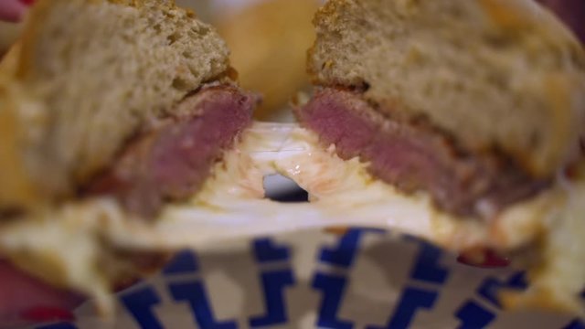 Splitting Portuguese Prego Steak Sandwich with creamy cheese, Close Up