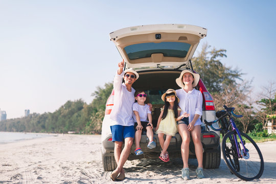 Happy Family They Are Sitting In The Family Car And Having Fun To Tease Each Other At The Sunny Day On The Peaceful Beach. Concept Happy Family On Vacation..