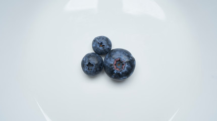 Closeup view of fresh blueberry on White plate