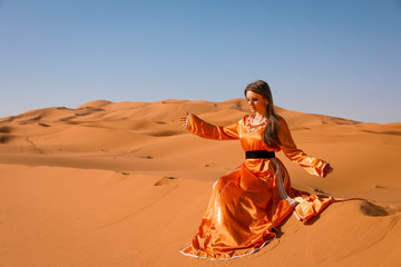 A girl in a beautiful Moroccan dress. Merzouga Morocco.