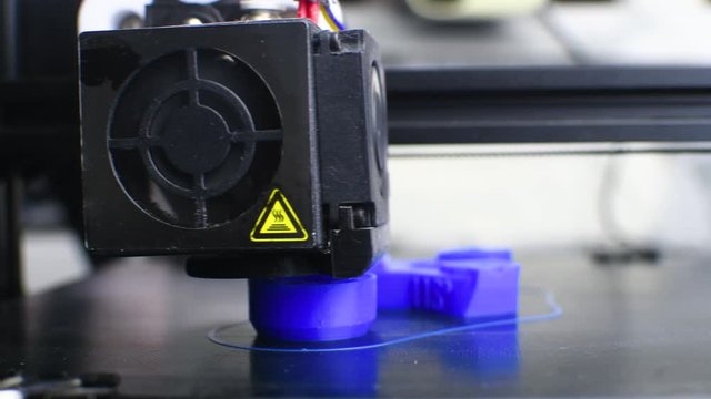 The 3D printer printed blue plastic model. modern technology