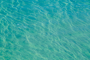 Fototapeta premium Blue pool water with sun reflections