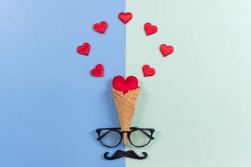 Happy Fathers Day background concept.Decorated ice cream cone, red heart, mustache, eyeglasses on bright pastel background with copy space. Top view, flat lay.
