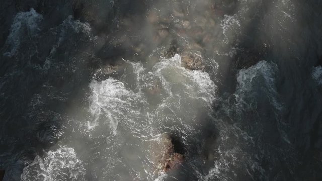 Beautiful Rushing River With Sun Beam Light Casting Over Waves From Overhead Position Slow Motion Oregon Pacific Northwest