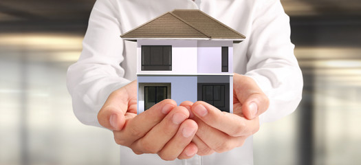 House Residential Structure in hand.  Concept of Investment propert and finance investment concep