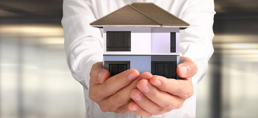 House Residential Structure in hand.  Concept of Investment propert and finance investment concep