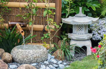 stone lantern and bamboo fountain in Japanese garden