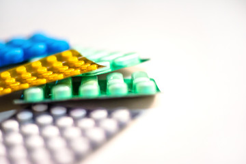 Colorful Many pills and tablets isolated on white background, pharmaceuticals antibiotic drug capsule pills in package.
