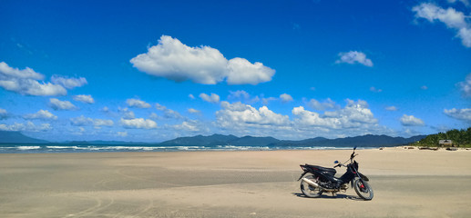 Motorcycle on a huge deserted beach on the island of palawan, philippines. 