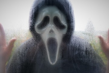 Halloween  costume.Scream mask.Masked killer. Horror and Halloween concept.A man in a suit and mask...