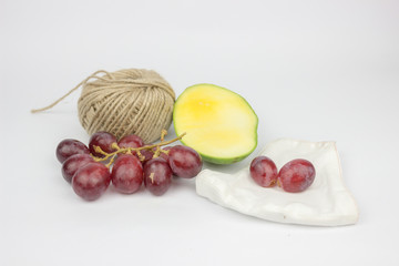 Grapes and green mango on a white background. fresh fruit