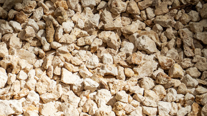 Mineral Background: A lot of small decorative rocks under the bright sunlight