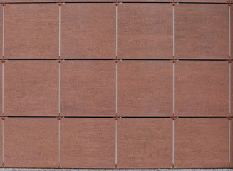 The wall is lined with brown tiles