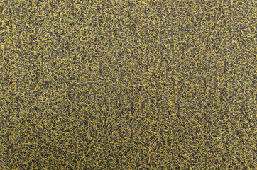 Fragment of floor covering of dirt-proof entrance mat, the surface of which consists of yellow and black rigid synthetic fibers in form of spaghetti. Abstract, two-tone futuristic design background.
