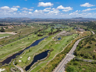 Fototapeta na wymiar Aerial view of a green golf course during sunny day in South California. USA