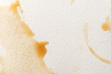 Abstract liquid drops splash brown coffee on a white texture paper background for watercolor. Artistic decoration or backdrop. Banner for text, grunge element.