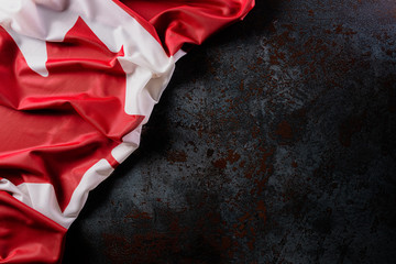 National flag of Canada on dark stone background, beautiful colored with cloth texture and copy...