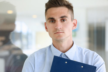 Handsome man in shirt stand in office