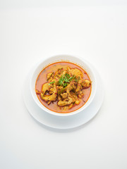 Panang chicken curry in white bowl.