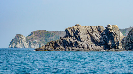 Fototapeta na wymiar Rocky island in front of the sea