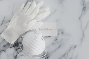 life after covid-19, lockdown sign next to mask and gloves