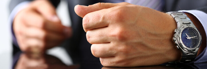 Empty arms of man in suit and tie closeup