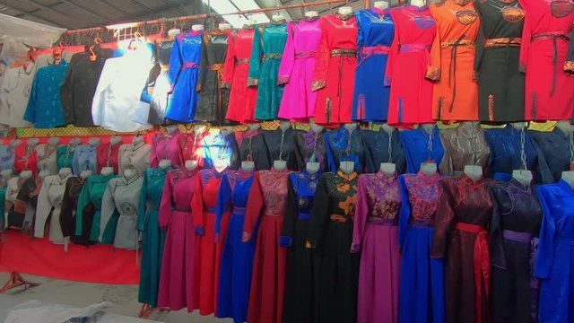 Rows Of Deel On Display. Traditional Women's Clothing For Sale At Naran Tuul Market. Ulaanbaatar, Mongolia.