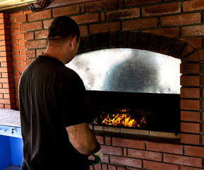 man roasts barbecue near the stove