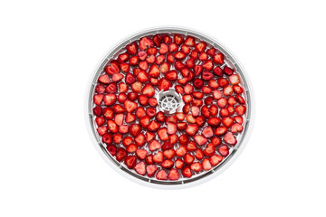 Dried strawberries cut into pieces of homemade. A dryer for making a delicious and healthy dessert isolated on white background.