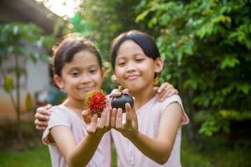 Thai fruit in two young girls, Thai girls show fruit in her hand