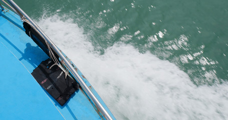 Ship motor creates waves on the surface of the ocean