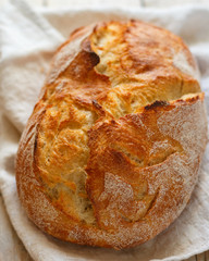 Freshly baked homemade traditional wheat bread close-up. The concept of baking. Selective focus