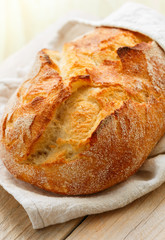 Freshly baked homemade traditional wheat bread close-up. The concept of baking. Selective focus